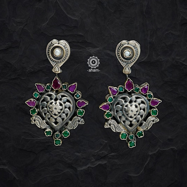 Complete your wardrobe with the elegance of these Double Sided Silver Earrings. Featuring pearls on one side and maroon and green stones on the other, crafted in silver, they can easily be switched up to match any outfit. Perfect for any occasion.