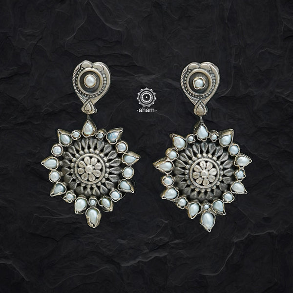 Complete your wardrobe with the elegance of these Double Sided Silver Earrings. Featuring pearls on one side and maroon and green stones on the other, crafted in silver, they can easily be switched up to match any outfit. Perfect for any occasion.