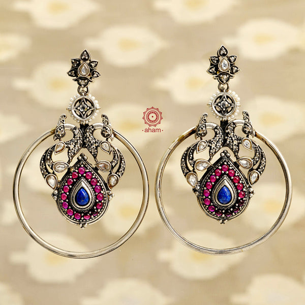 Experience the stunning beauty of our Festive Peacock Silver Earrings. These statement earrings feature intricate marcasite work and are expertly crafted in 92.5 silver. Elevate any outfit and make a bold fashion statement with these elegant and eye-catching earrings. Perfect for any festive occasion.