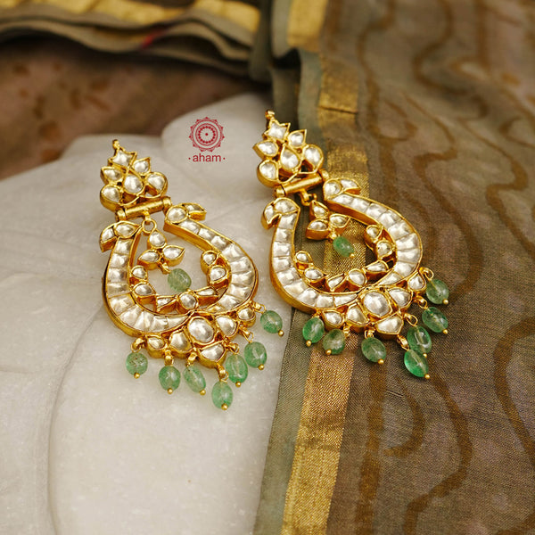 Statement gold polish chandbali earring with beautiful green drops. Handcrafted using traditional methods in 92.5 sterling silver with gold polish. Pair these with your ethnic outfits this festive season to ace your look.