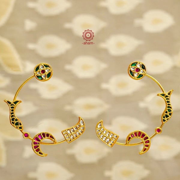Add a touch elegance to your outfit with our Crescent Gold Polish Silver Earrings. Featuring intricate kundan work and symbols of flowers, fish, moon, and tiger teeth, these 92.5 silver earrings are beautifully crafted and finished with a gold polish. Elevate your style with these unique and charming earrings.