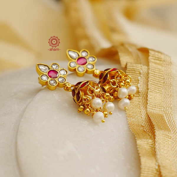 Elegant gold polish Earrings embellished with kundan and kemp work. Handcrafted in 92.5 sterling silver and dripped in gold polish. Perfect for special occasions and festivities.