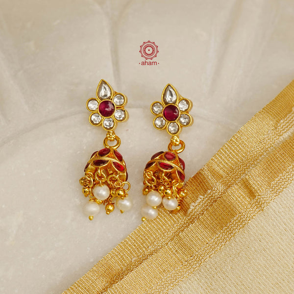Elegant gold polish Earrings embellished with kundan and kemp work. Handcrafted in 92.5 sterling silver and dripped in gold polish. Perfect for special occasions and festivities.
