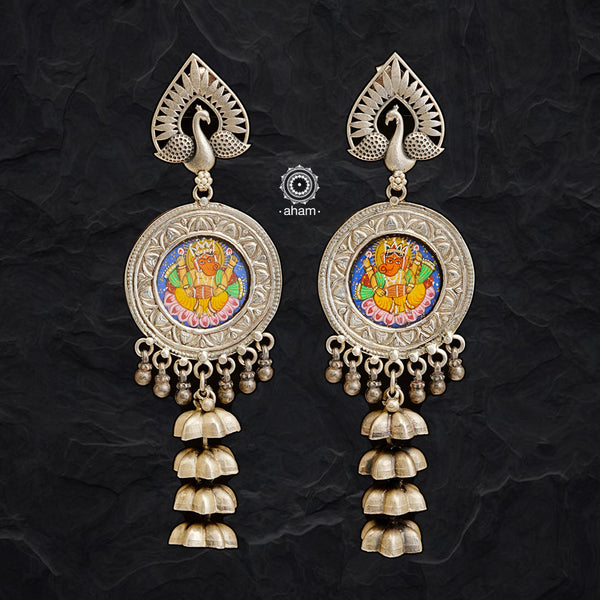 Handcrafted 92.5 sterling silver jhumkie earrings. With an intricate miniature hand painted Ganesha Motif in vibrant colours, enclosed with a glass top, with floral motifs in the back. These are hand painted one of a kind wearable art pieces. 