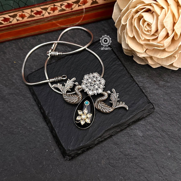 Handmade Black stone pendant with Mughal Inspired intricate floral inlay work in semi precious stone setting, encased in silver and two perfect peacocks and kundan highlights. Wear it long or short with a chain of your choice, or a smart silver Hasli. A piece so timeless that it can we worn across generations. Please note, each piece created in this series is unique and one of a kind. (Does not include chain)