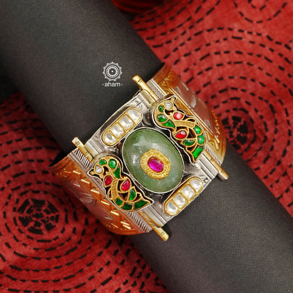Noori peacock hand cuff with a play of colours, textures, forms and workmanship. Crafted in 92.5 Sterling Silver with two tones that make them so versatile and unique. The price is for one piece kada only. 