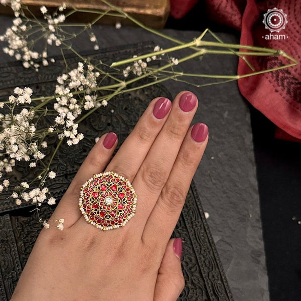 Festive gold polish adjustable ring handcrafted in silver with beautiful red kundan and laced with pearls. Perfect for special occasions and festivities. 