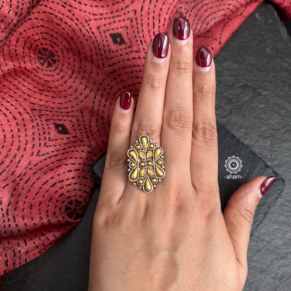 Enhance your style with the timeless elegance of the Two Tone Silver Ring. Handcrafted by skilled karigars in Barmer, Rajasthan, this kada features traditional Bandhel work, where a thin sheet of 22 carat hand beaten gold is set on silver using a unique wax filling technique. A classic representation of Indian craftsmanship.