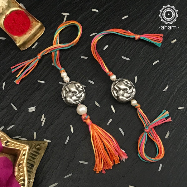 Make this Rakshabandhan Memorable with this handcrafted Ganesha  Rakhi Lumba set crafted in 925 Silver and weaved with cotton thread.   Roli (kumkum), Akshat (Chawal) and Mishri shipped along with India orders only  Tip: you can later convert this into a key chain charm or a pendant as well  Please note, Rakhi Orders will be packed and shipped in a single box only and not multiple boxes.