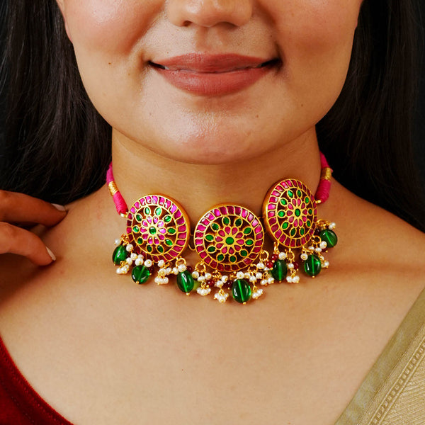 Beautiful gold polish flower choker with green & pink Kundan work. Handcrafted 92.5 sterling silver with semi precious beads and pearls. Pair this neckpiece with your ethnic outfits this festive season to complete the look.