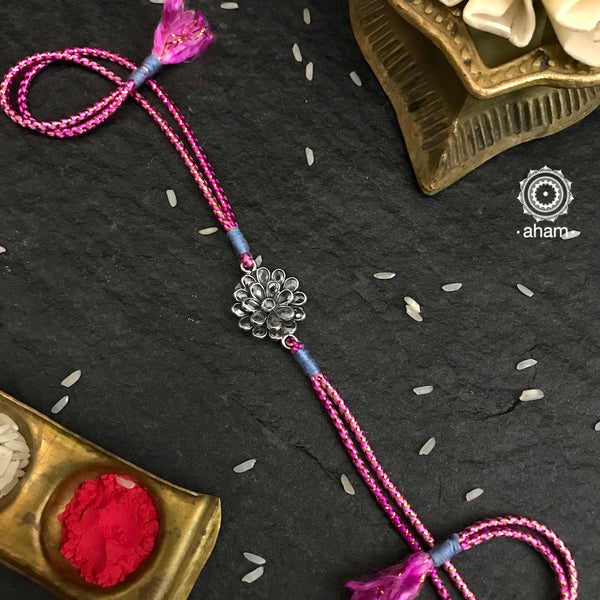 Make this Rakshabandhan Memorable with this handcrafted silver Rakhi. Elegant Zircon Rakhi in 925 Silver weaved with pink resham thread.  Roli (kumkum), Akshat (Chawal) and mishri shipped along with India orders only  Tip: you can later convert this into a key chain charm or a pendant as well   Please note, Rakhi Orders will be packed and shipped in a single box only and not multiple boxes.