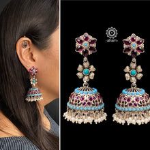 Handcrafted pair of Nrityam three layer jhumkie earrings in 92.5 sterling silver. Comes with floral motifs, blue and kemp stone setting and hanging cultured pearls. 
