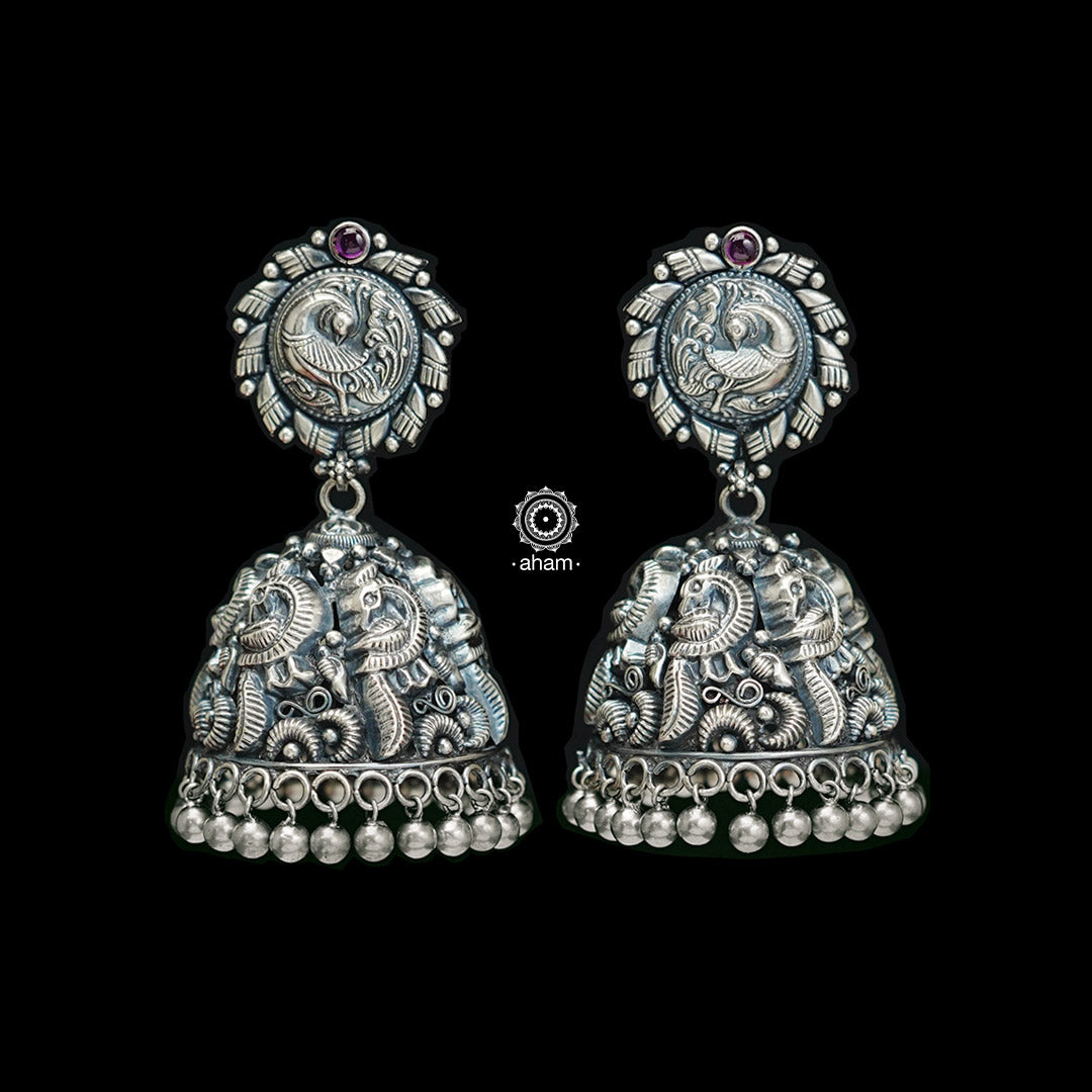Experience the beauty of South Indian temple architecture with this exquisite Peacock Nakshi Work Silver Jhumkie. Crafted from 92.5 silver, this statement piece is sure to make a lasting impression. Perfect for special occasions.