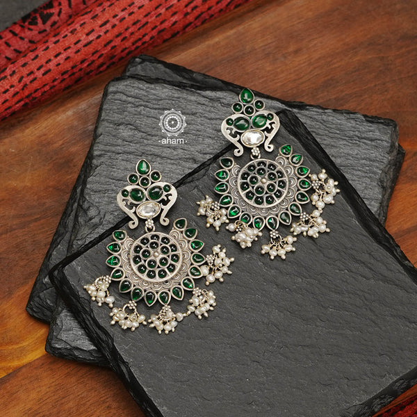 Handcrafted pair of Nrityam earrings in 92.5 sterling silver. laced with little pearls, these ethnic wear earrings are a great addition to your collection. 