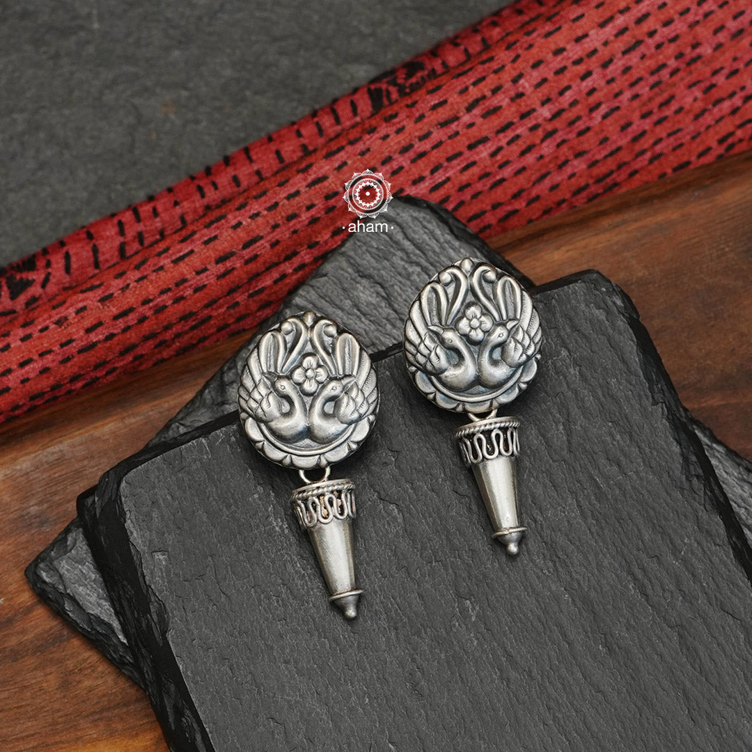 Mewad Peacock earrings with intricate floral work. Handcrafted in 92.5 sterling silver. An ode to the glorious state of Rajasthan. Perfect work wear earrings.