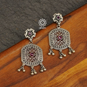 Mewad heart earrings with intricate floral work. Handcrafted in 92.5 sterling silver with dangling ghungroos. An ode to the glorious state of Rajasthan. 