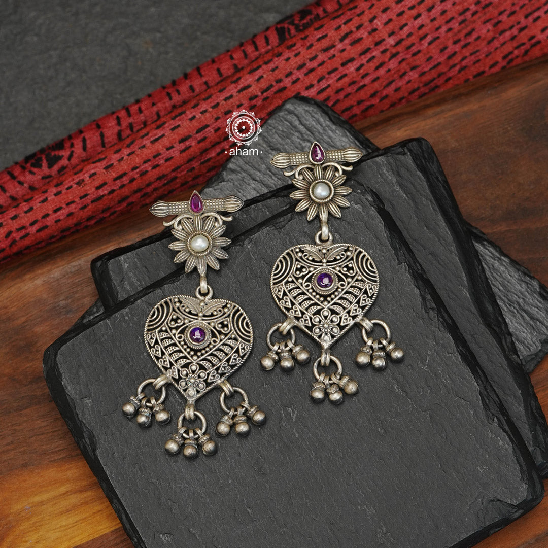 Mewad heart earrings with intricate floral work. Handcrafted in 92.5 sterling silver with dangling ghungroos.   An ode to the glorious state of Rajasthan. 