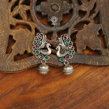 Mewad peacock earrings handcrafted in 92.5 sterling silver with vibrant stone highlights and a ball drop. An ode to the glorious state of Rajasthan. Light weight great as everyday and ethnic wear. 