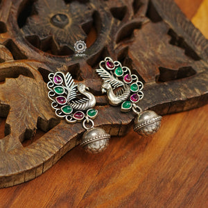 Mewad peacock earrings handcrafted in 92.5 sterling silver with vibrant stone highlights and a ball drop. An ode to the glorious state of Rajasthan. Light weight great as everyday and ethnic wear. 