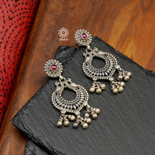 Mewad double peacock earrings handcrafted in 92.5 sterling silver with maroon stone highlight. An ode to the glorious state of Rajasthan. Perfect pair of elegant danglers for your ethnic outfits. 