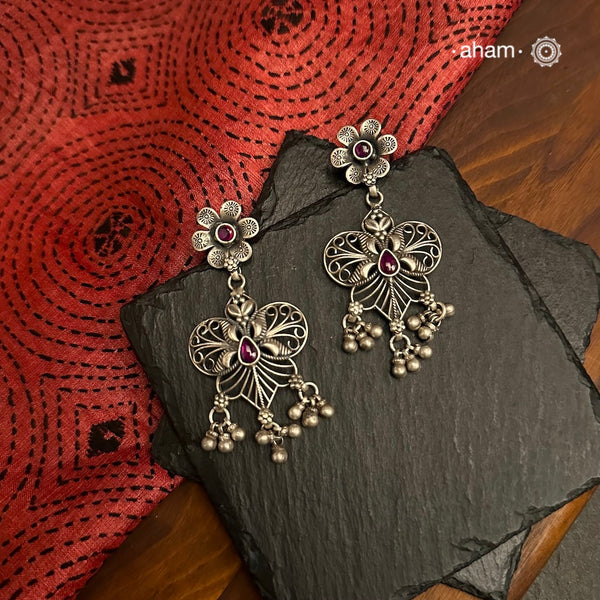 Crafted in 92.5 silver, the Mewad Silver Earrings feature delicate floral designs accented with kemp highlights. These elegant earrings are perfect for adding a touch of charm to any outfit.