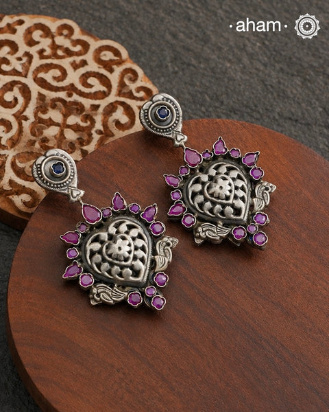 Complete your wardrobe with the elegance of these Double Sided Silver Earrings. Featuring maroon and deep blue stones, crafted in silver, they can easily be switched up to match any outfit. Perfect for any occasion.