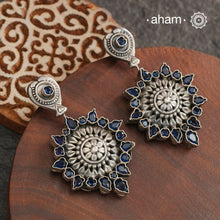 Complete your wardrobe with the elegance of these Double Sided Silver Earrings. Featuring maroon and deep blue stones, crafted in silver, they can easily be switched up to match any outfit. Perfect for any occasion.