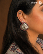 Summer love drop stud earrings with intricate double peacock motif. Handcrafted in silver with maroon coloured stone setting. Looks great with your everyday ethnic outfits.