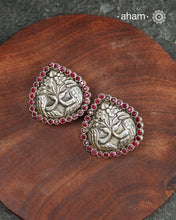 Summer love drop stud earrings with intricate double peacock motif. Handcrafted in silver with maroon coloured stone setting. Looks great with your everyday ethnic outfits.