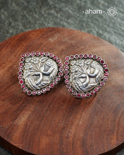 Summer love drop stud earrings with intricate double peacock motif. Handcrafted in silver with maroon coloured stone setting. Looks great with your everyday ethnic outfits.