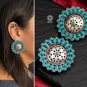 Beautiful silver studs with cut work center and turquoise coloured stone highlights. Crafted in 92.5 silver, these are great statement makers.