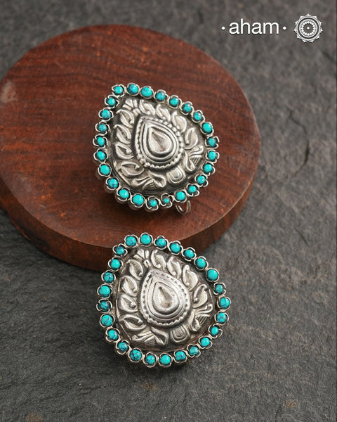 Summer love drop stud earrings with beautiful thapi work in the center and turquoise stone highlights. Handcrafted in 92.5 silver. Looks great with your everyday ethnic outfits.