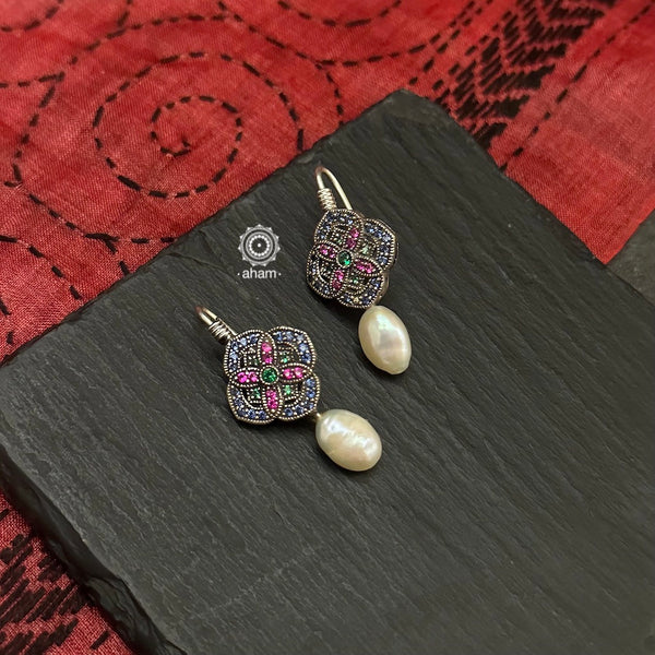 Make a sophisticated style statement with these delicate earrings crafted in 92.5 sterling silver with remarkable craftsmanship of stone setting finished off with a pearl drop. 