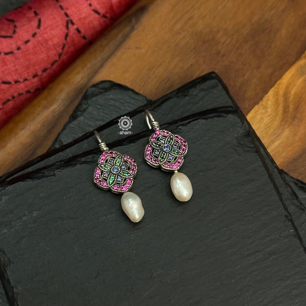 Make a sophisticated style statement with these delicate earrings crafted in 92.5 sterling silver with remarkable craftsmanship of stone setting finished off with a pearl drop.