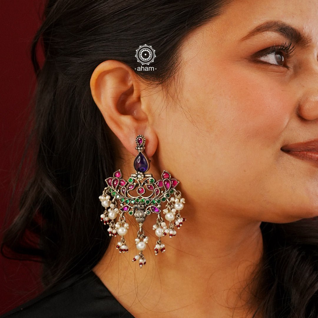 Handcrafted floral motifs with semi precious stones and cultured pearl detail these chandelier 92.5 sterling silver earrings will add more bling and drama to your jewellery collection. Style this up with your favourite silk saree or even your lehengas. 