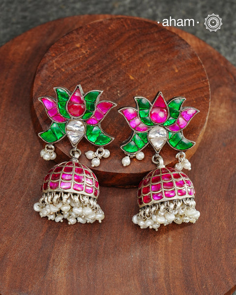 Handcrafted in 92.5 sterling silver with dangling cultured pearls, rani (pink) and kundan work.These festive lotus jhumkie earrings will add more bling and drama to your jewellery collection.
