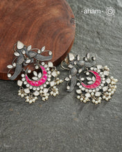 Handcrafted in 92.5 sterling silver with cultured pearls, double peacock motifs with pink spinels and kundan work. These festive&nbsp;jhumkie&nbsp;earrings will add more bling and drama to your jewellery collection.
