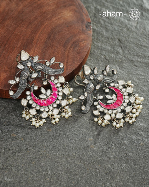 Handcrafted in 92.5 sterling silver with cultured pearls, double peacock motifs with pink spinels and kundan work. These festive&nbsp;jhumkie&nbsp;earrings will add more bling and drama to your jewellery collection.