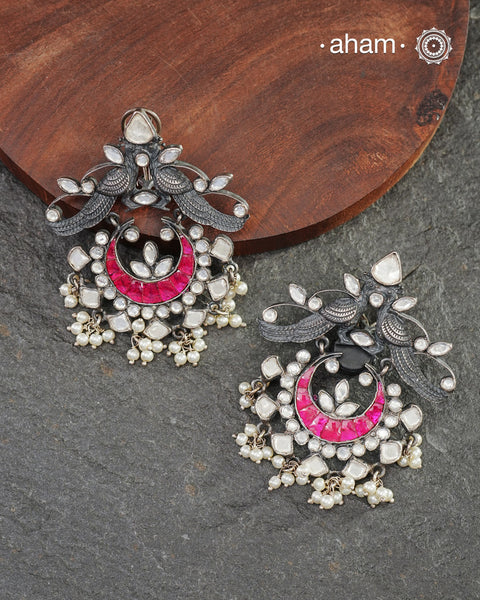 Handcrafted in 92.5 sterling silver with cultured pearls, double peacock motifs with pink spinels and kundan work. These festive&nbsp;jhumkie&nbsp;earrings will add more bling and drama to your jewellery collection.