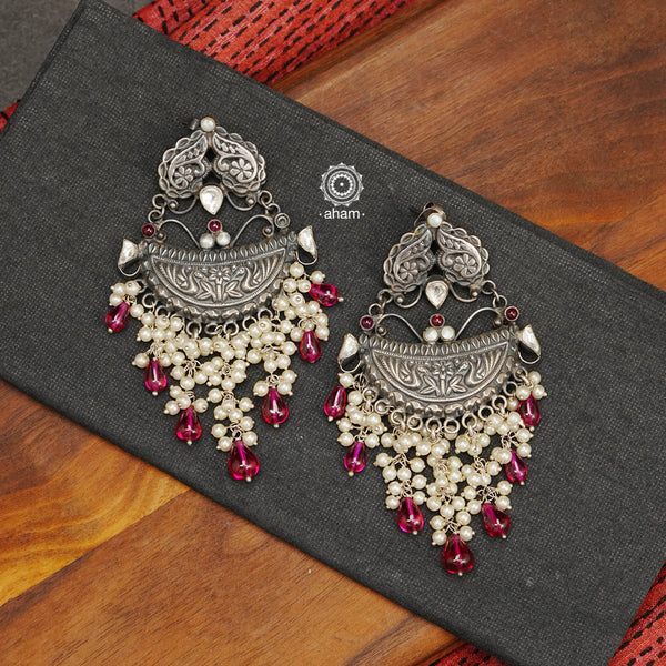 Handcrafted in 92.5 sterling silver with cultured pearls, double peacock motifs with spinels and kundan work. These festive earrings will add bling and drama to your jewellery collection.