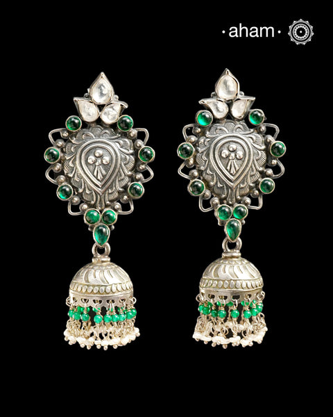 Beautiful light weight silver jhumkie crafted in 92.5 silver with green stone highlights.