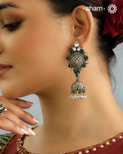 Beautiful light weight silver jhumkie crafted in 92.5 silver with green stone highlights.