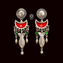 Crafted with precision, these Rang Mahal Silver Earrings feature a unique red drop design with a fish motif. Combining 92.5 sterling silver with vibrant colored glass creates a magical, eye-catching accessory.