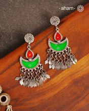 Statement Rang Mahal green &amp; red diya earrings with dangling charms, handcrafted in 92.5 sterling silver. The magic that happens when glass, silver and a pop of colour come together.