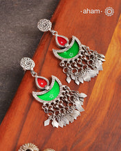 Statement Rang Mahal green &amp; red diya earrings with dangling charms, handcrafted in 92.5 sterling silver. The magic that happens when glass, silver and a pop of colour come together.