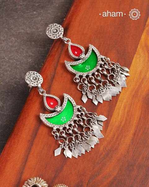 Statement Rang Mahal green &amp; red diya earrings with dangling charms, handcrafted in 92.5 sterling silver. The magic that happens when glass, silver and a pop of colour come together.