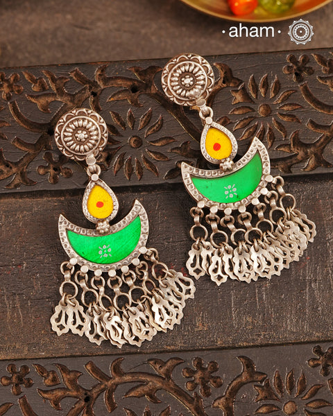 Statement Rang Mahal green & yellow diya earrings with dangling charms, handcrafted in 92.5 sterling silver. The magic that happens when glass, silver and a pop of colour come together.