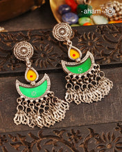 Statement Rang Mahal green &amp; yellow diya earrings with dangling charms, handcrafted in 92.5 sterling silver. The magic that happens when glass, silver and a pop of colour come together.