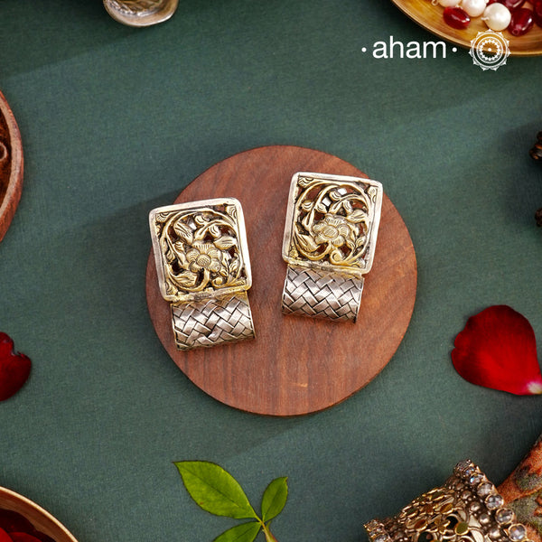 Contemporary two tone earrings handcrafted in 92.5 sterling silver with floral chitai work. These earrings look elegant paired with any outfit from Dawn to Dusk.