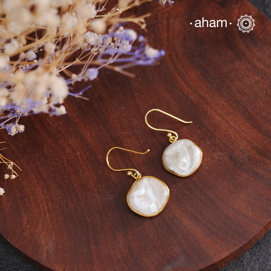 Shimmer and shine with these Mother of Pearl Gold Polish Silver Earrings! The natural mother of pearl is set in stylish silver with a touch of gold polish. The easy fishhook makes them light weight and a perfect go-to for any outfit. Dress them up or down, they'll be your new fave!

Keep in mind that these are natural forms, so both earrings in the set will have a similar shape, but not an exact match.